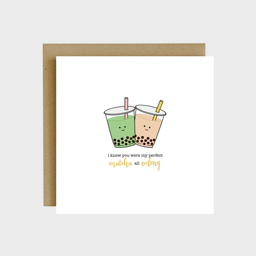 A funny greeting card featuring two cups of milk tea with boba and text that reads, I knew you were my perfect matcha all oolong.