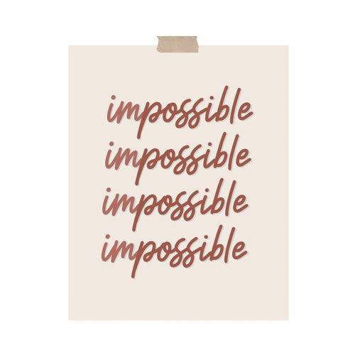 An art print featuring the word “impossible” in calligraphy where the word is separated by two colors for “im” and “possible” hung with a piece of kraft tape on the top.