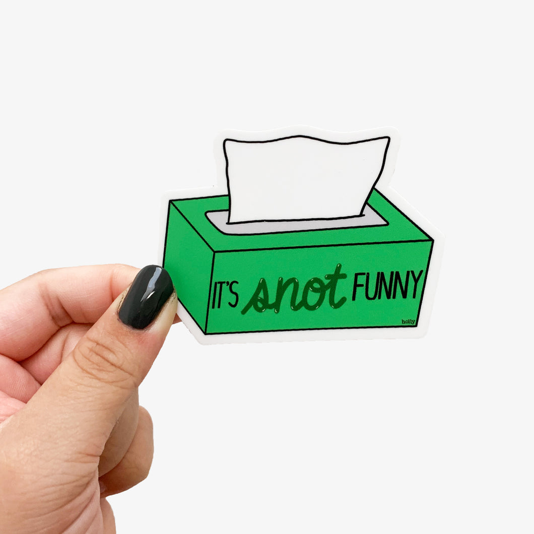 A funny pun sticker featuring a green tissue box with one tissue coming out and text that reads, It’s snot funny.