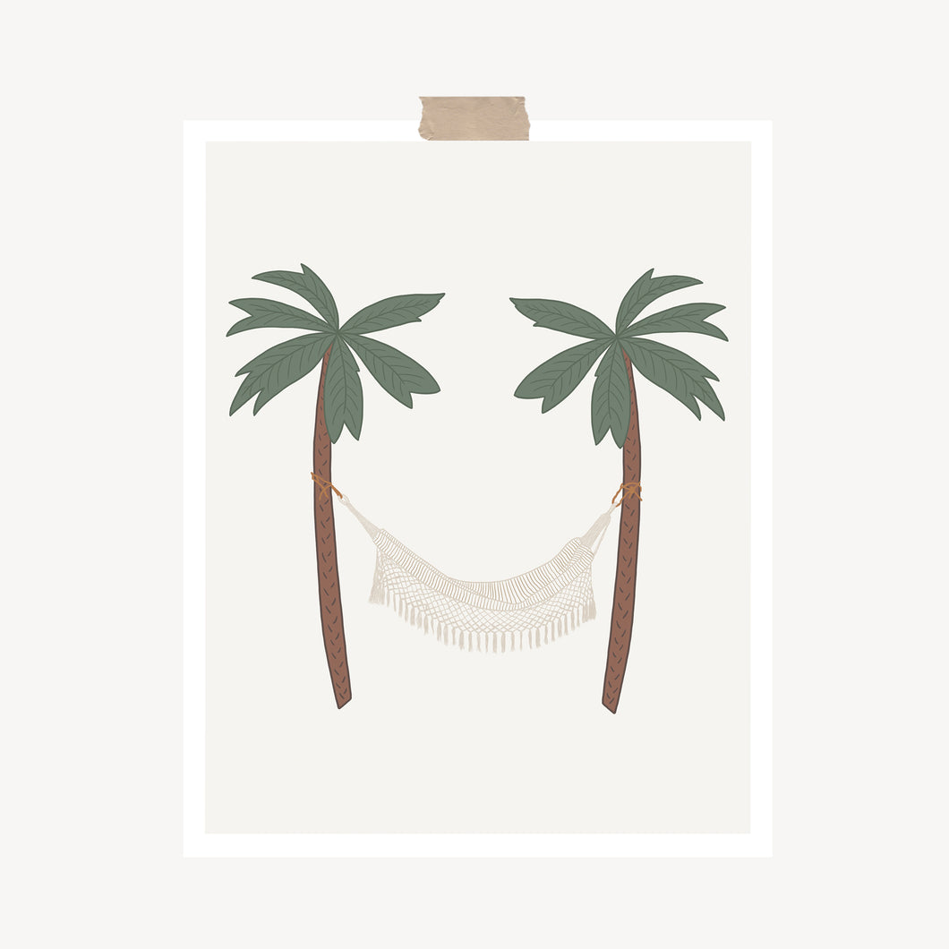 An art print featuring a cream boho hammock hung between two palm trees hung with a piece of kraft tape on the top.