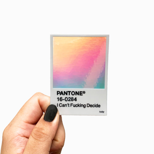 A funny sticker featuring a Pantone paint swatch that has a holographic center as the swatch color and text that reads, I Can’t Fucking Decide as the name of the paint swatch.