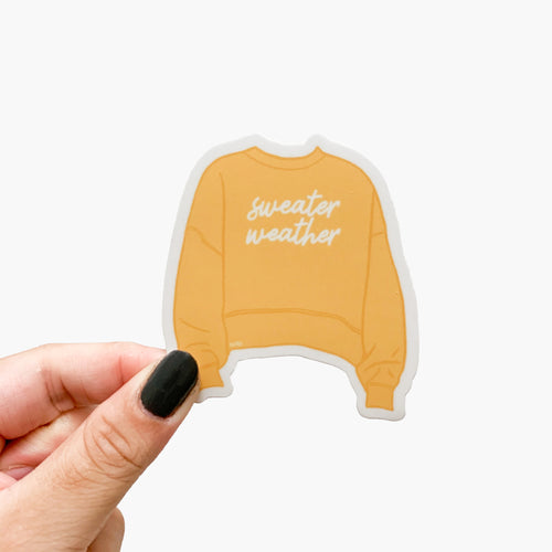 A sticker featuring a cozy yellow sweater and text that reads, Sweater weather.